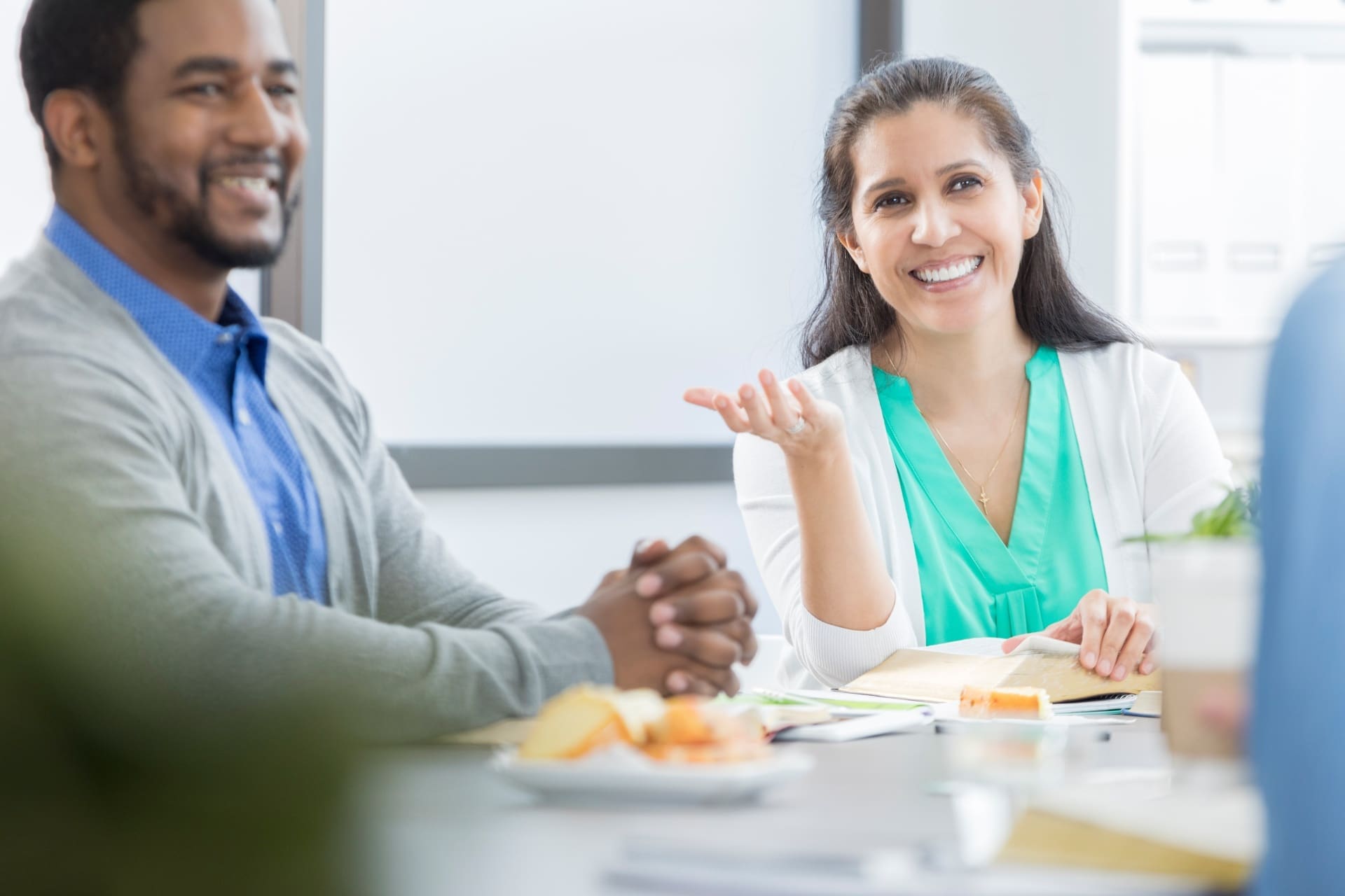 Image of 2 business people talking over a table